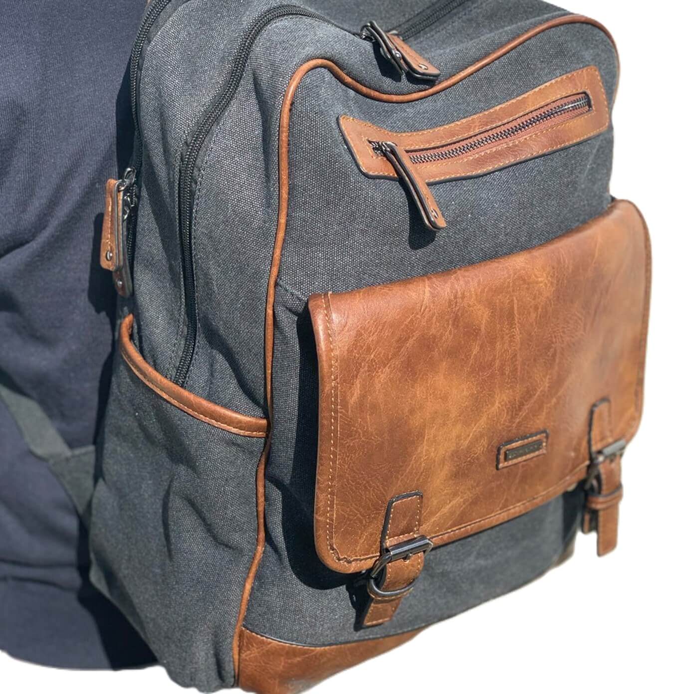 Black backpack with brown leather accents on a white background